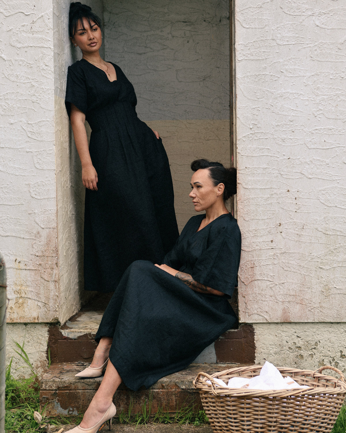 Winnie black linen maxi dress with poutama embroidery – two women in a garden doorway