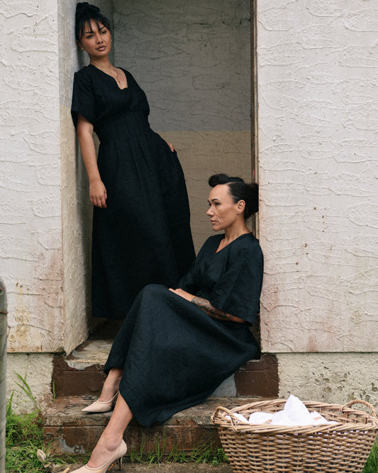 Winnie black linen maxi dress with poutama embroidery – two women in a garden doorway